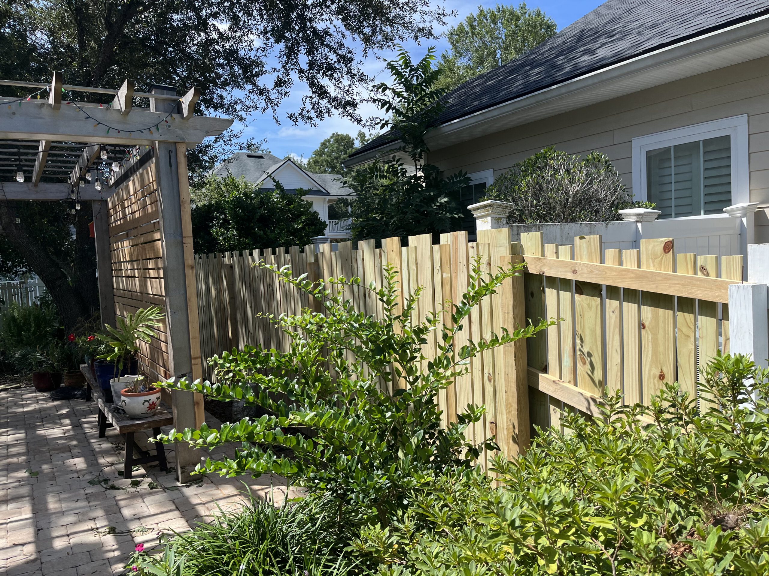 Wood fence with arbor and landscaping