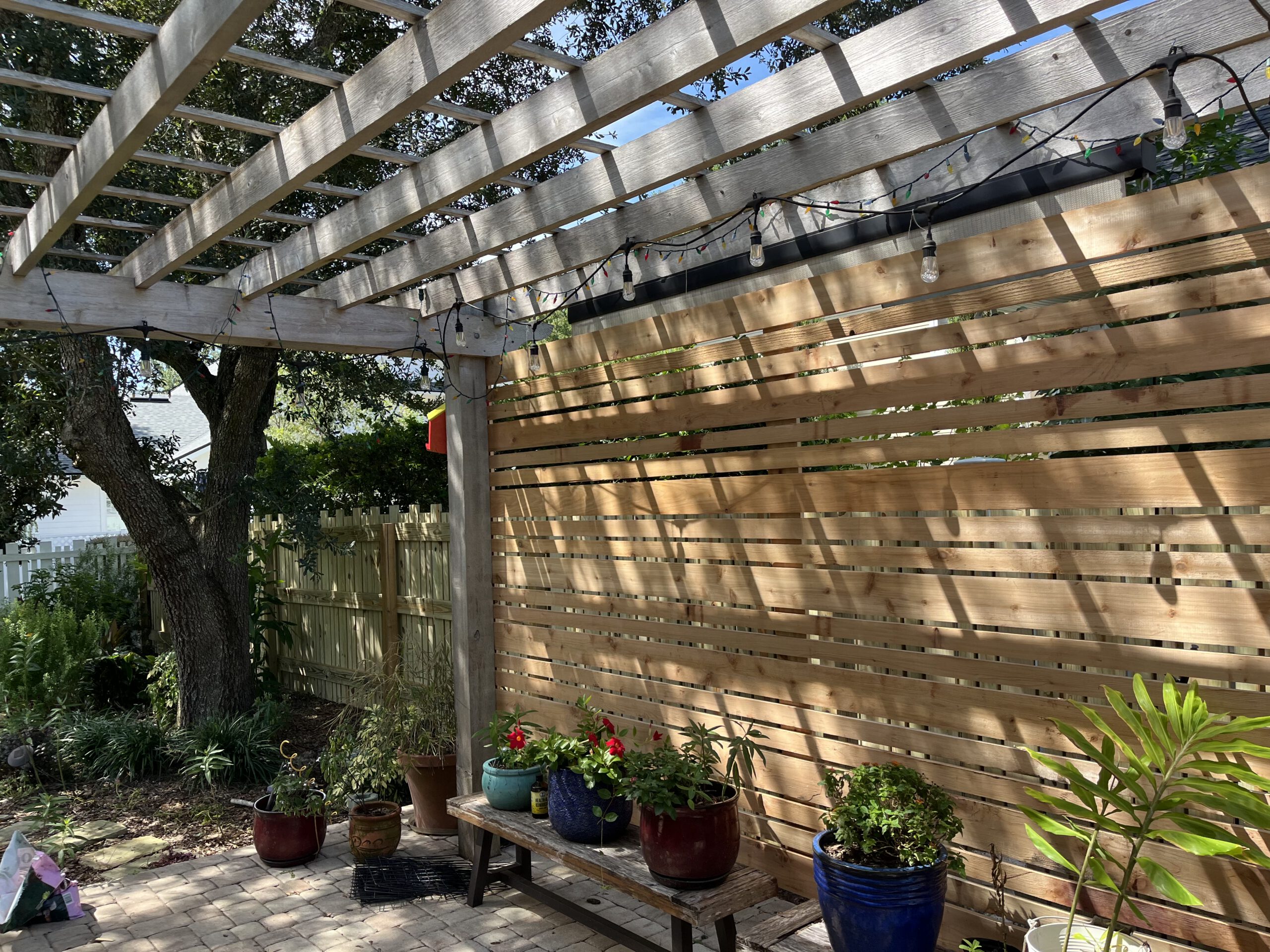 Pergola with horizontal slat fence