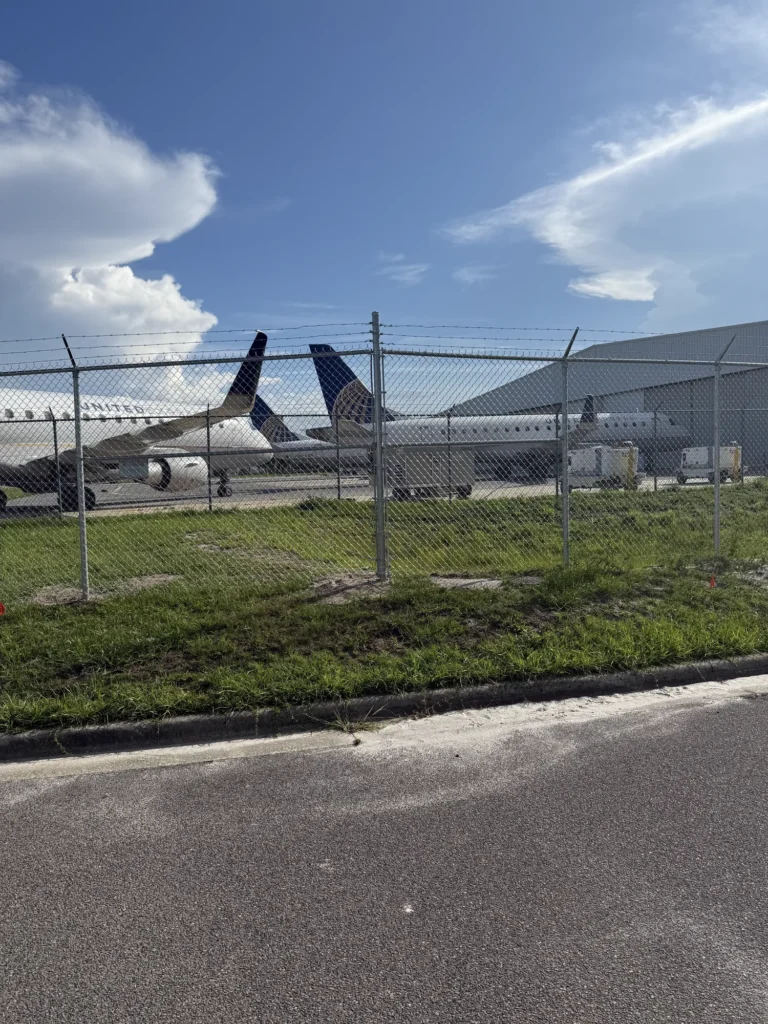 Airport perimeter chain link fence with three-strand barbed wire