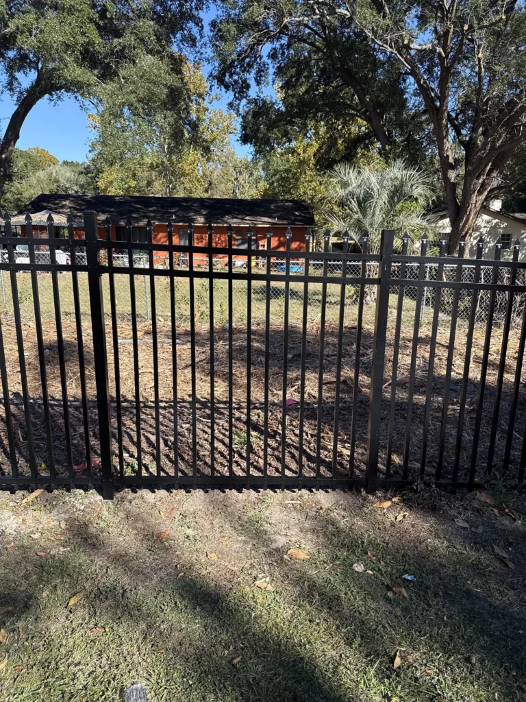 Black aluminum spear-top fence along a residential property line