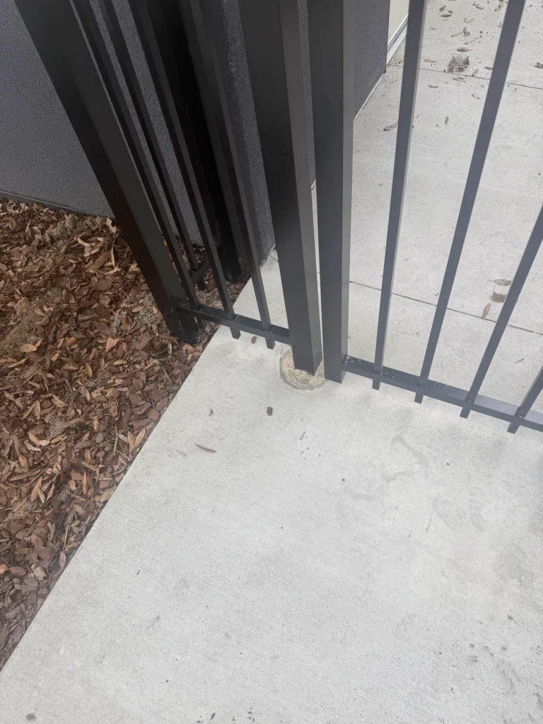 Core-drilled post detail on a black aluminum equipment enclosure