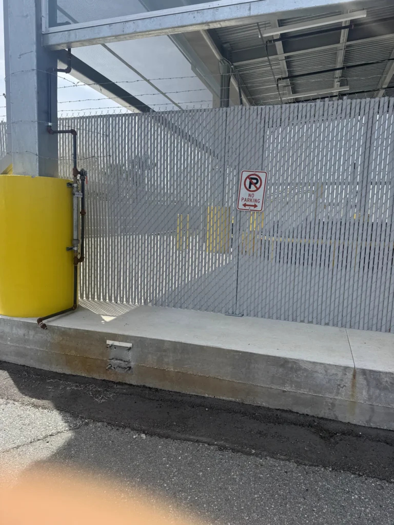 Privacy slat chain link fence enclosing a commercial loading dock