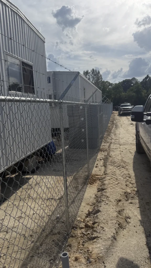 Construction site security fencing along a contractor staging area
