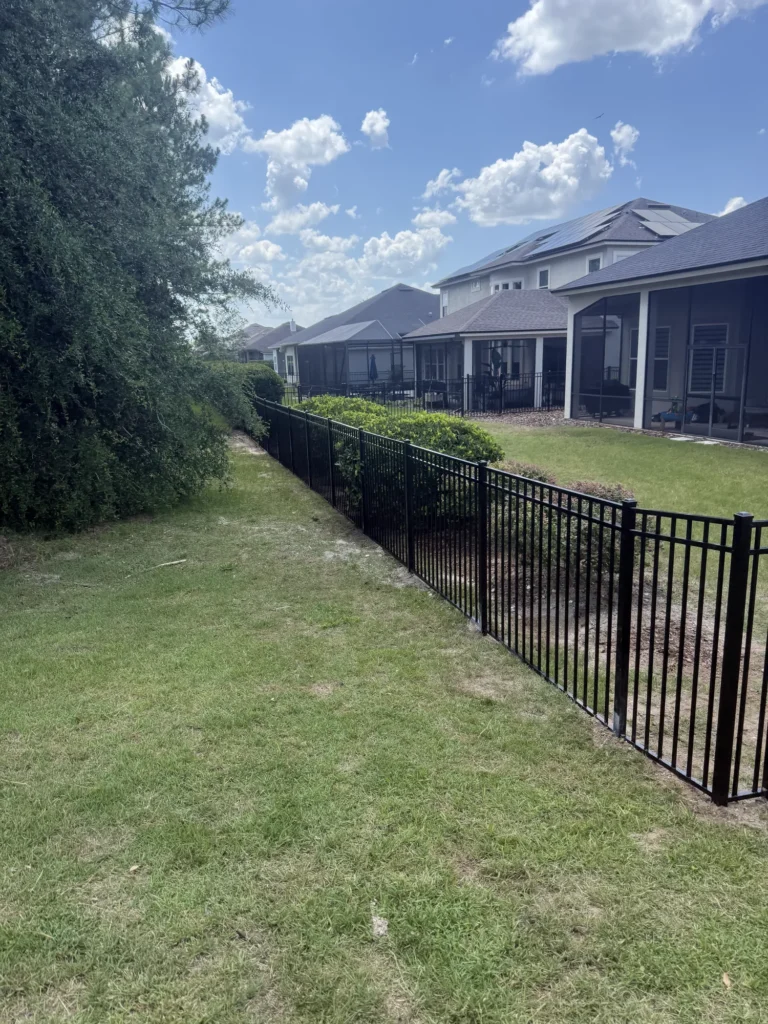 Black aluminum backyard fence in a Florida subdivision